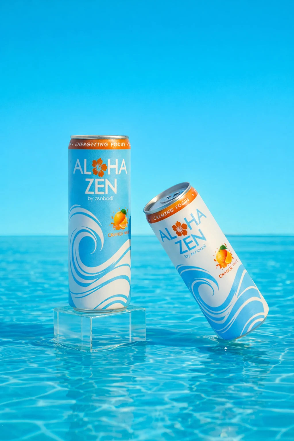Two Aloha Zen Orange Wave cans in bright turquoise pool water
